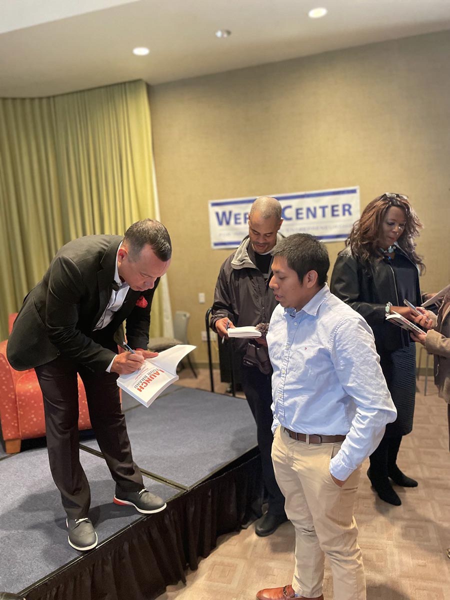 Ramon signing books